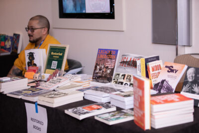 Justin Valas, Founder & Proprietor of Restoried Bookshop, running Restoried's social justice bookshop.