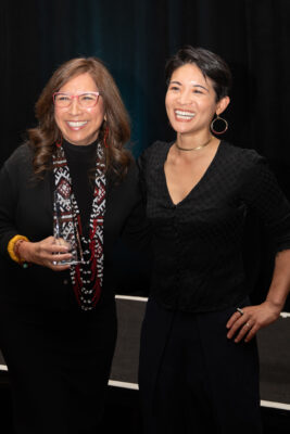 Lori Villarosa posing with her Urvashi Vaid Intersectional Leadership Award and her sister.
