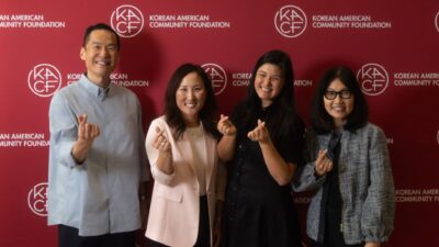 Four philanthropic leaders pose in front of a Korean American Community Foundation (KACF) step-and-repeat banner, each making the Korean finger heart gesture. From left to right: Daniel Lee (Haas Jr. Fund), Anne Im (Silicon Valley Community Foundation), Connie Chung Joe (AAPIP), and Catha Cha (Freedom Together).